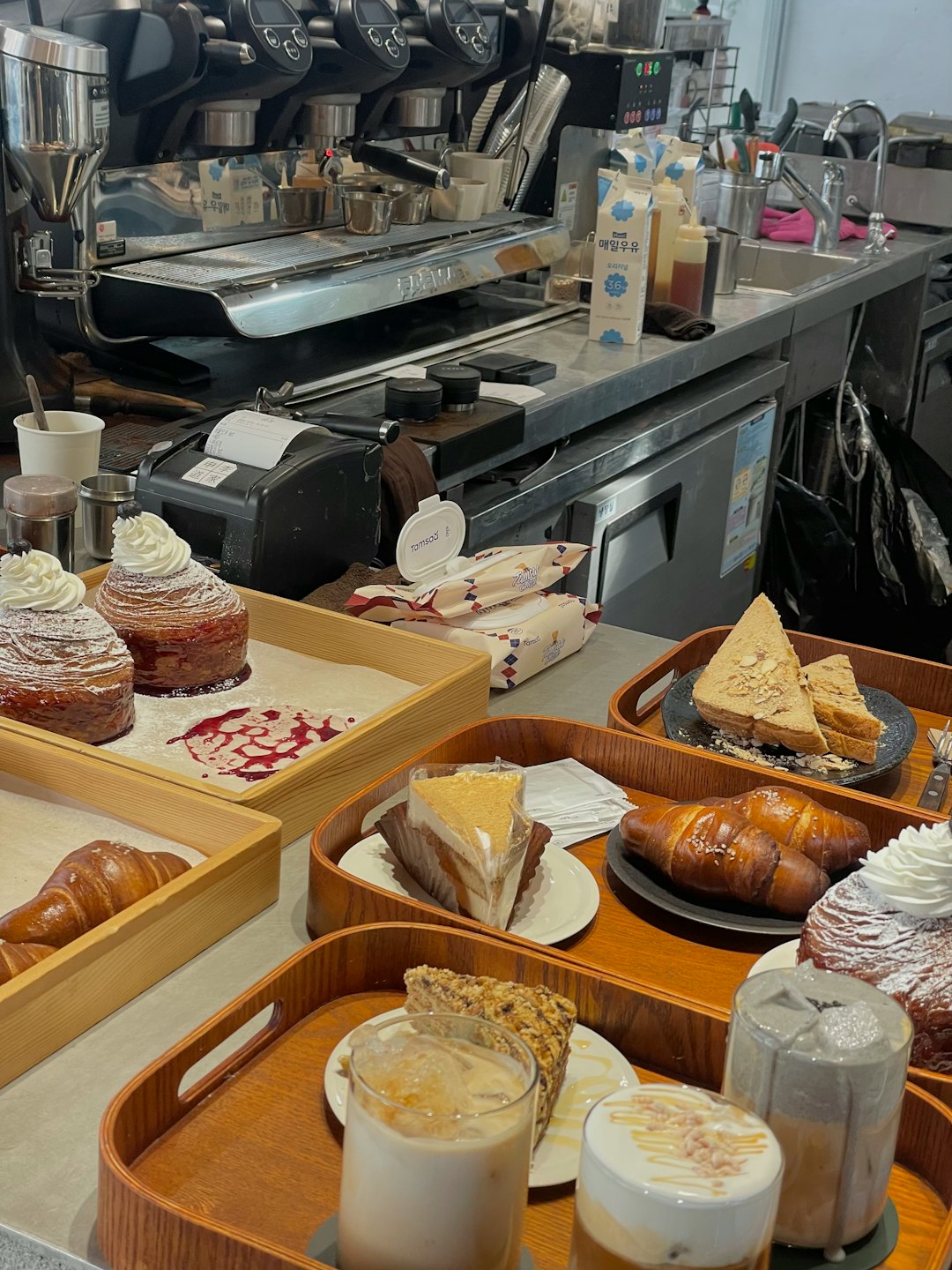 Pastries and iced drinks displayed on a cafe counter.